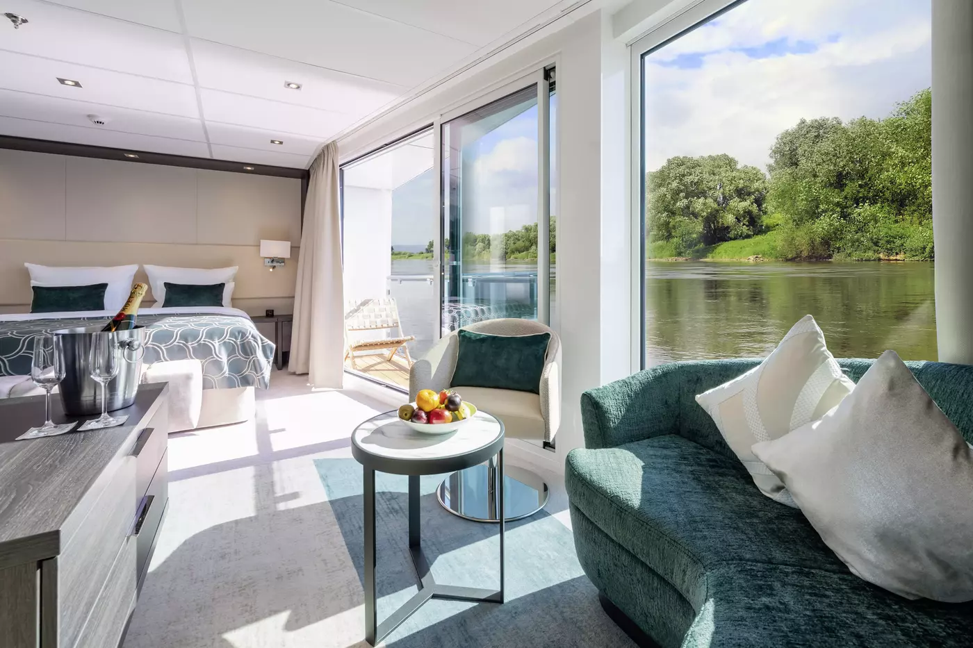 An AMADEUS Suite on the AMADEUS Cara, with its sitting area and sliding door to a walk-out balcony